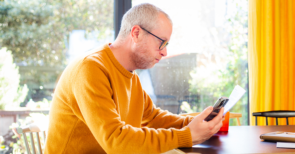 A man reviewing a document while at home