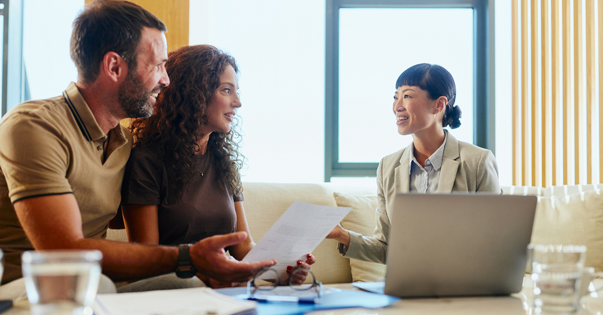 An agent meets with her clients in the office